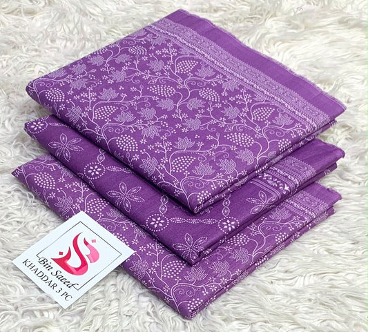 Folded amethyst purple Bin Saeed khaddar 3 piece unstitched suit with white botanical print.