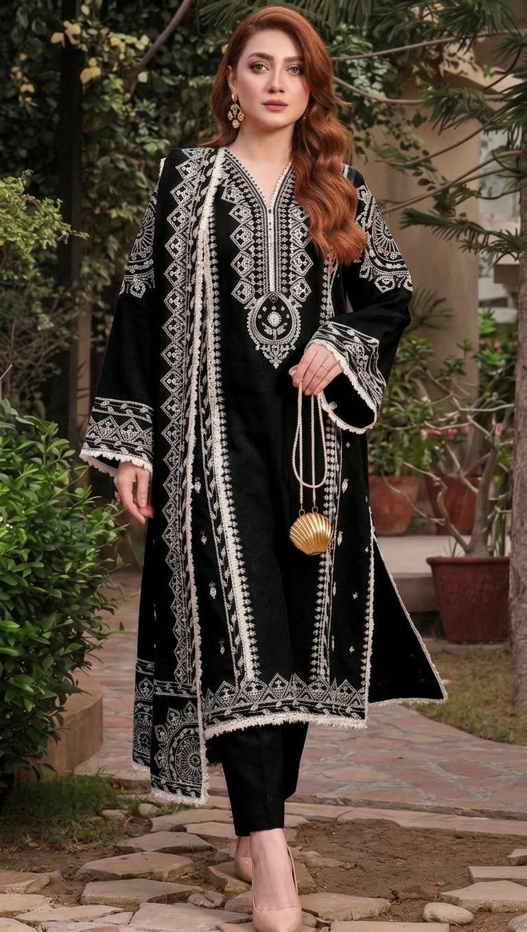 Model wearing a classic black Aneelas Dhanak 3pc suit with striking white embroidery from the winter collection sale unstitched.