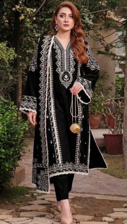 Model wearing a classic black Aneelas Dhanak 3pc suit with striking white embroidery from the winter collection sale unstitched.