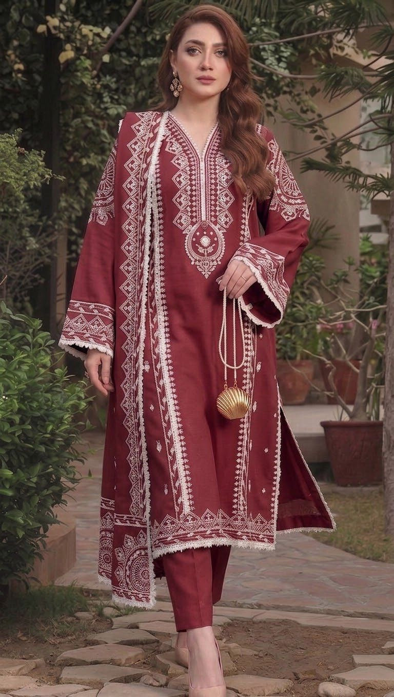 Model wearing a deep maroon Aneelas Dhanak 3pc suit with white embroidery from the winter collection sale unstitched.