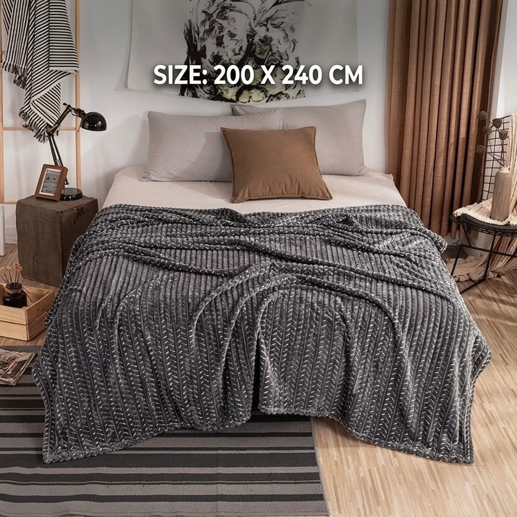 Elegant grey luxury fleece AC blanket featuring a modern zigzag texture spread across a double bed.