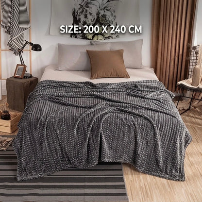 Elegant grey luxury fleece AC blanket featuring a modern zigzag texture spread across a double bed.