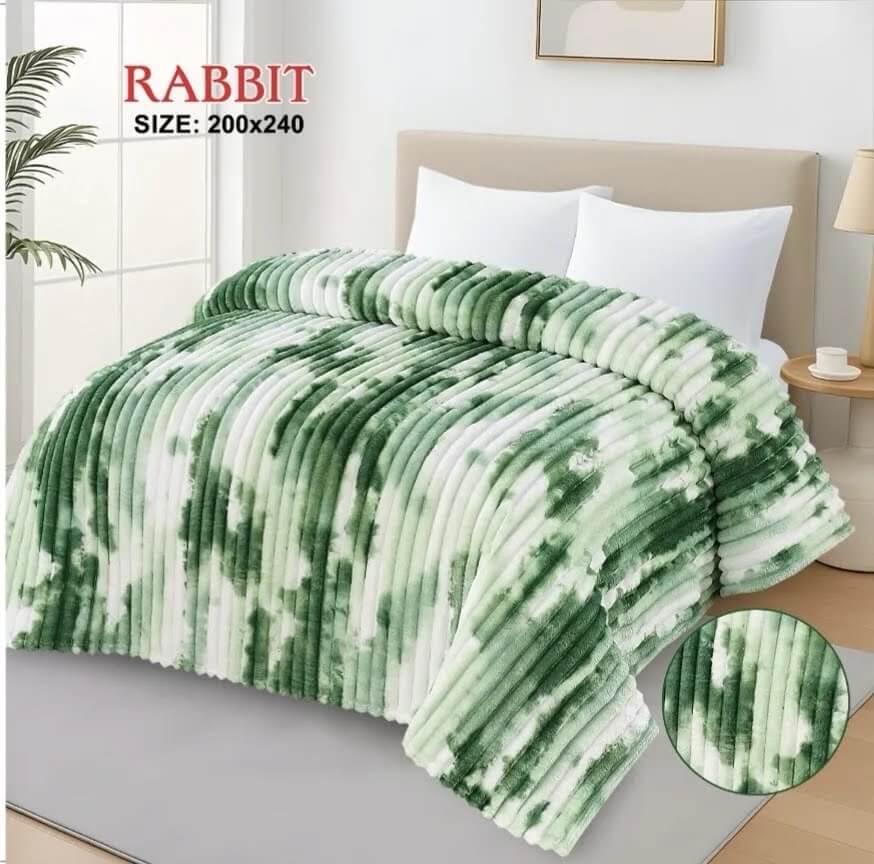 Luxury AC blanket for double bed in a green and white marble pattern, draped over a modern bed.