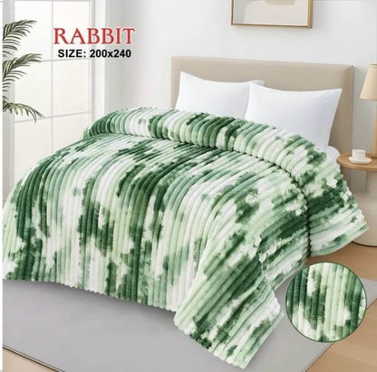 Luxury AC blanket for double bed in a green and white marble pattern, draped over a modern bed.