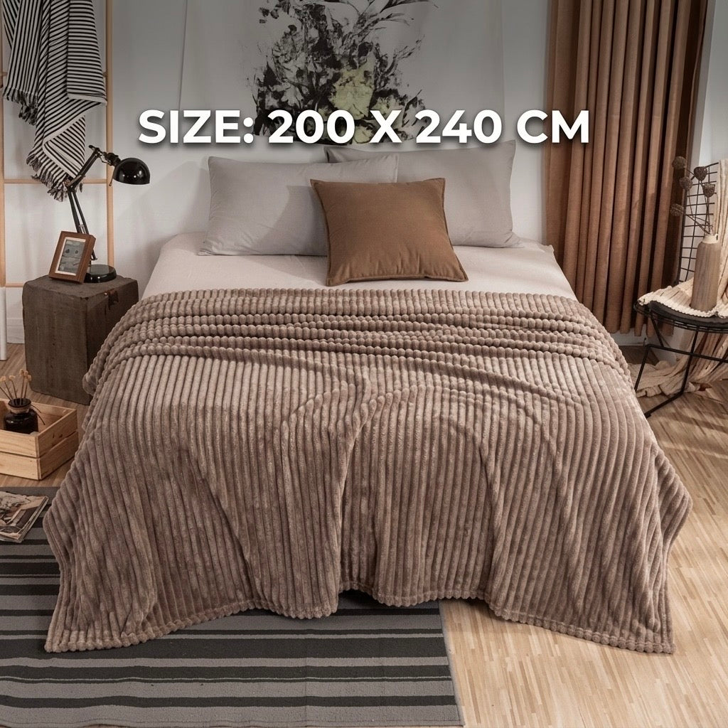 Warm beige luxury fleece AC blanket with a ribbed texture, draped gracefully over a modern double bed.