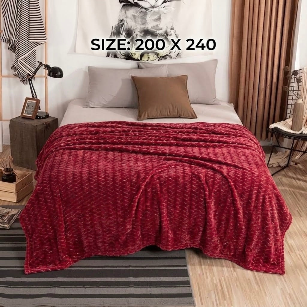  Deep red luxury fleece AC blanket in king size with an elegant textured pattern on a bed.