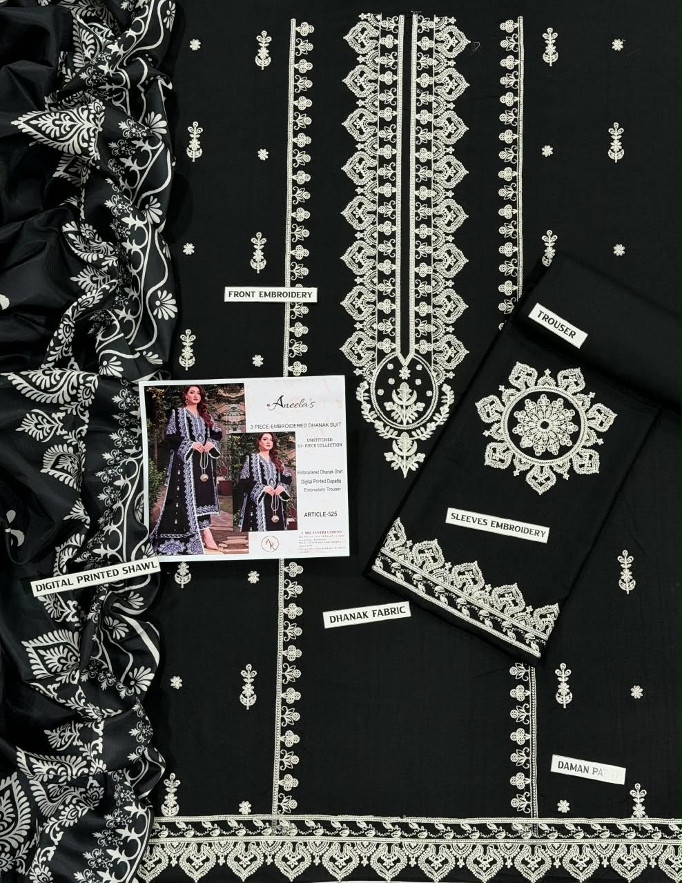Close-up of heavy white geometric and floral embroidery contrasting beautifully against premium black Airjet Dhanak fabric.